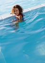 Splish Splash. Portrait of a happy little girl playing in the pool.