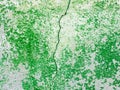 Split abstract surface cracked in the middle as green paint peeling off a concrete wall background. Old grungy, weathered painted Royalty Free Stock Photo