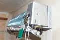 Split air conditioner closeup repair and maintenance concept. The specialist repairs the wall air conditioner. Inverter Air