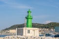 Split, Croatia - Aug 15, 2020: Green lighthouse at old port in early morning