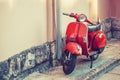 SPLIT, CROATIA - JULY 09, 2017: Red vintage scooter parked near a building wall - outdoors shot - Split, Croatia