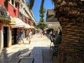 hot summer day along the oceanfront boardwalk of Split, Croatia. People are walking amongst the many shops and restaurants