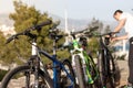 Split,Croatia May 2020 Blue green and black mountain bikes standing on a wall. Scott and Cube branded popular bikes, man fiddling