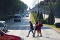 Split Croatia September 2020 Several people walking accross a sidewalk, in the middle of the street. White ambulance van in the Royalty Free Stock Photo