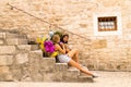 Split Dalmatia. Croatia. 09/06/2018: Split, Dalmatia, Croatia; 09/07/2018: Girls sitting on the steps