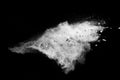 Split debris of stone exploding with white powder against black background Royalty Free Stock Photo