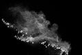 Split debris of stone exploding with white powder against black background Royalty Free Stock Photo