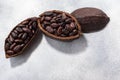 Split fermented cocoa pod with shelled cacao beans atop light grey backdrop, top view,  copy space Royalty Free Stock Photo