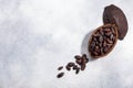 ÃÂ«Split fermented cocoa pod with shelled cacao beans atop light grey backdrop, top view, copy space