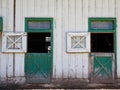 Green Doors in Weathered White Barn Royalty Free Stock Photo