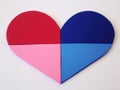 A split heart with red and blue halves. The concept illustrates division or duality.