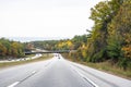 Split highway road with a bridge and autumn trees on the sides in New Hampshire Royalty Free Stock Photo