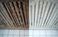 Split image shows dirty and clean stove hood filter grill comparison. Grease build up removed from kitchen ventilation system. Royalty Free Stock Photo