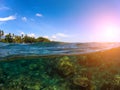 Split landscape with sea and sky. Double photo with tropical island and underwater coral reef. Royalty Free Stock Photo