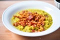 split pea soup with crumbled bacon on top, close up shot