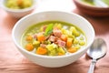 split pea soup with diced vegetables and ham bits