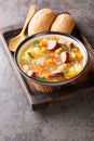 Split pea soup with potato, onion, carrot, bacon and sausages close-up in a bowl. Vertical Royalty Free Stock Photo