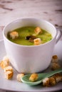 Split pea soup in white cup and croutons Royalty Free Stock Photo