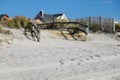 Split rail fence lining a pathway over sand dunes and high grass entering a white sandy beach Royalty Free Stock Photo