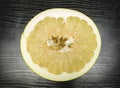 Split ripe fruit pomelo on the table. Royalty Free Stock Photo