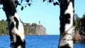 Split Rock Ligthhouse and Lake Superior in Minnesota seen between trees.