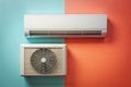 Split Air Conditioner System with White Indoor and Outdoor Units on Dual Tone Blue and Orange Wall Royalty Free Stock Photo
