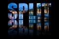 Split text composed of city landscape on black background with text reflection in water Royalty Free Stock Photo