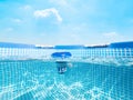 Split underwater view of a chlorine floater dispenser in a pool Royalty Free Stock Photo