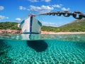 Split view - half underwater view of beautiful seabed with sea fishes and beautiful marine yacht, Turkey, Bodrum Royalty Free Stock Photo