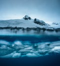 Split view of an iceberg showing above and below the water line, Antarctica. Arctic Greenland. Climate change and global