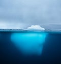 Split view of an iceberg showing above and below the water line. Underwater iceberg. Antarctica. Arctic Greenland