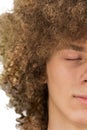 Splited in half cropped portrait of a young curly European man with long curly hair and closed eyes close up. very lush male hair Royalty Free Stock Photo