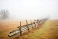 splitrail fence trailing off into the foggy landscape