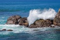 Splitting the sea wave on the stone shore