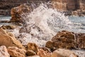 Splitting waves against picturesque rocks in the sea