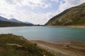 Spluegenpass with the Monte Spluga reservoir and surrounding mountains in summer