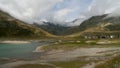 Spluegenpass with the Monte Spluga reservoir and surrounding mountains in summer