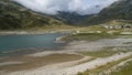 Spluegenpass with the Monte Spluga reservoir and surrounding mountains in summer