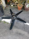 Spoiled black ceiling fan thrown on the street