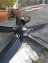 Spoiled black ceiling fan thrown on the street