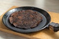 spoiled burned pancake in a frying pan