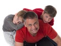 Spoiled children on their fathers back Royalty Free Stock Photo