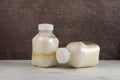 Spoiled dairy products in disposable plastic bottles. Bloated swollen bottles. Fermented sour milk. Concept - Improper storage of