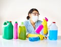 Spoilt for choice on what to use for chores. a young woman holding various bottles of detergents.