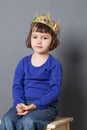 Spoilt kid concept for serious preschool child with crown on
