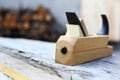 Spokeshave, plane in carpentry workshop on wood. Close-up Royalty Free Stock Photo