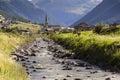 Spol river with church of Santa Maria in Livigno Italy