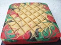 Sponge cake with colourful random patterns. Placed on a white table.