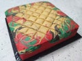 Sponge cake with colourful random patterns. Placed on a white table.