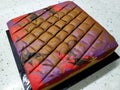 Sponge cake with colourful random patterns. Placed on a white table.